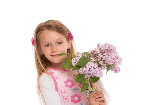 Happy little girl with long hair wearing summer dress and holding lilac flowers. Isolated on white background.