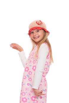 Smiling little girl with long hair wearing summer dress and knit cap. Isolated on white background.