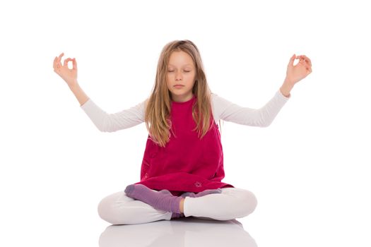 Young girl with long hair wearing red dress and making yoga exercises. Isolated on white background.