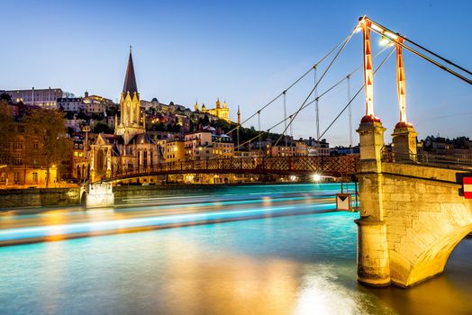 night view from St Georges footbridge in Lyon city with Fourviere cathedral, France