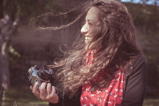 hipster vintage woman with old camera in the park
