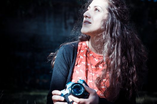 hipster vintage woman with old camera in the park