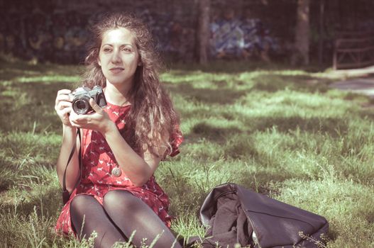 hipster vintage woman with old camera in the park