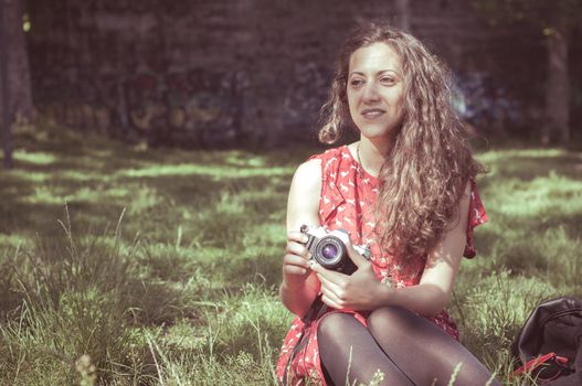 hipster vintage woman with old camera in the park