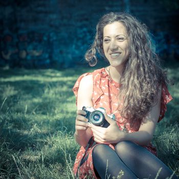 hipster vintage woman with old camera in the park