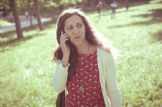 hipster vintage woman on the phone at the park
