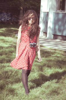 hipster vintage woman with old camera in the park