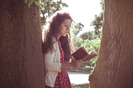 eastern hipster vintage woman reading book in the park