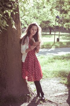 eastern hipster vintage woman reading book in the park