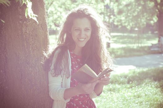eastern hipster vintage woman reading book in the park