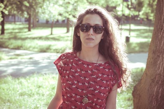 eastern hipster vintage woman with shades at the park
