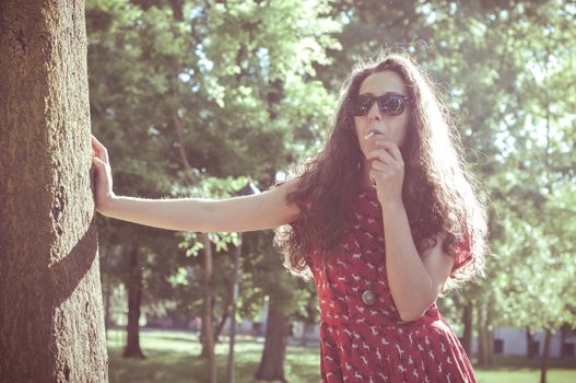 eastern hipster vintage woman with shades at the park
