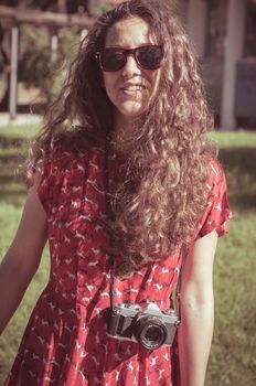 hipster vintage woman with old camera in the park