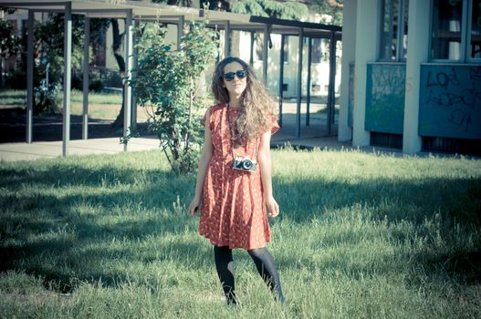 hipster vintage woman with old camera in the park