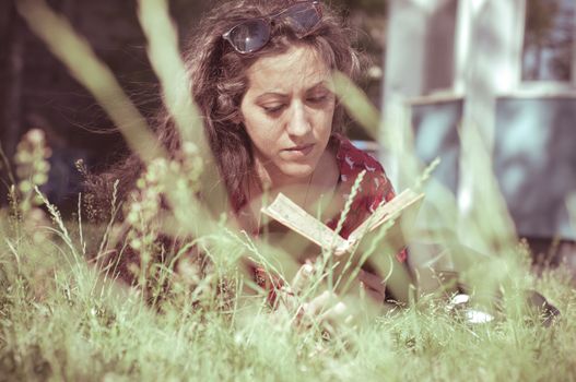 eastern hipster vintage woman reading book in the park