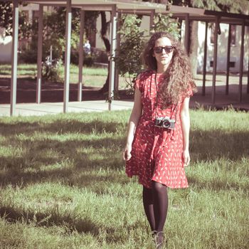 hipster vintage woman with old camera in the park