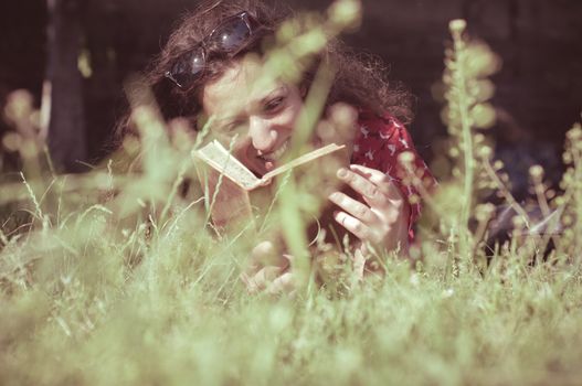 eastern hipster vintage woman reading book in the park