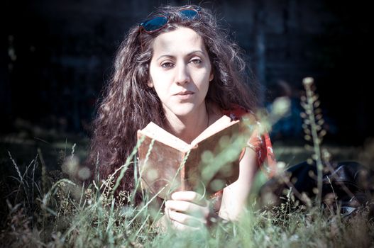 eastern hipster vintage woman reading book in the park