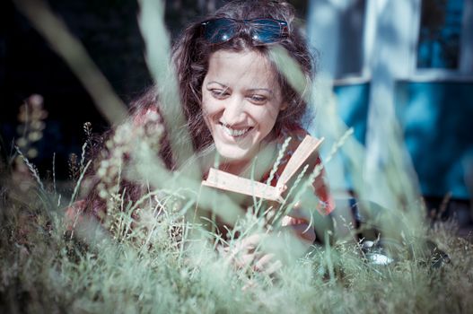 eastern hipster vintage woman reading book in the park
