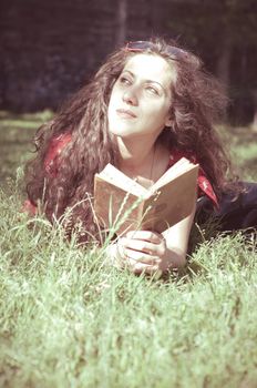 eastern hipster vintage woman reading book in the park