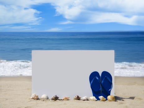 White board with flip-flops and seashells on sandy beach 