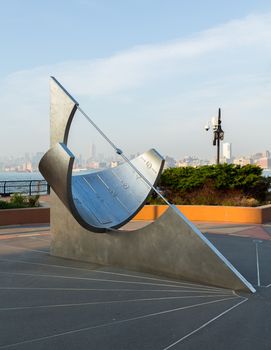 JERSEY CITY, NJ, USA - 22 MAY: Equatorial Sundial in Jersey City in front of midtown New York on 22 May 2013. The sundial was designed by Robert Adzema