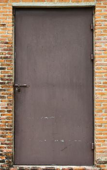 Old steel door on the brick wall.