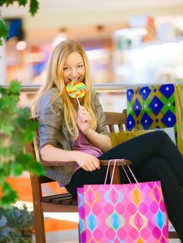 happy girl with shopping bags in shop