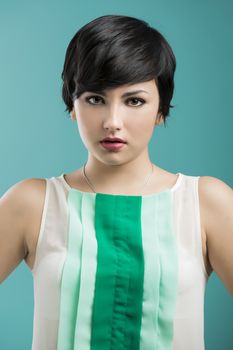 Portrait of a beautiful and fashion woman aganist a blue background