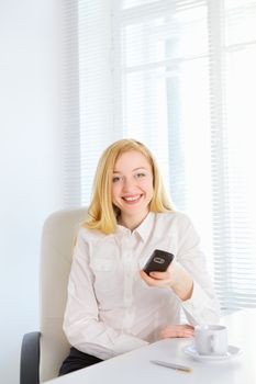 happy office girl with cellphone at table