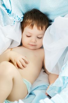 funny little boy sleeping in cradle, portrait