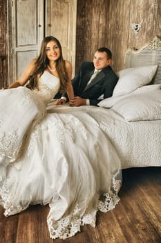 charming bride and groom in their bedroom