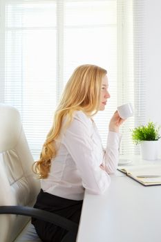 happy office girl drink coffee at break