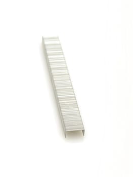 Row of staples for stapler on white background