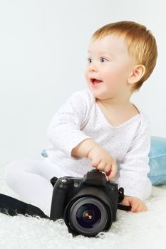 beautiful little blond baby with dslr camera