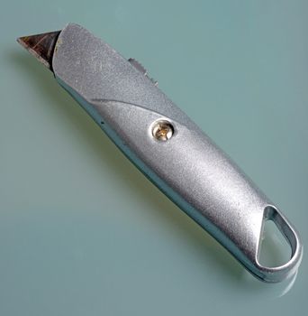 box cutter knife on plain background with nobody