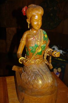 Wood statuette representing a Thai woman in her colorful costume