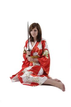 french young girl geisha in red silk kimono with japanese sword