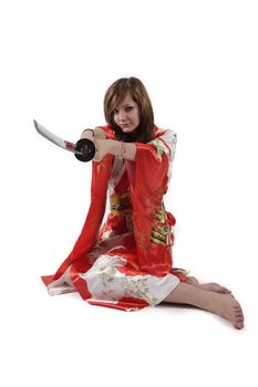 french young girl geisha in red silk kimono with japanese sword