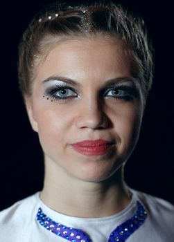 Closeup portrait of circus performer looking to the camera. Woman 23 years old. Caucasian.