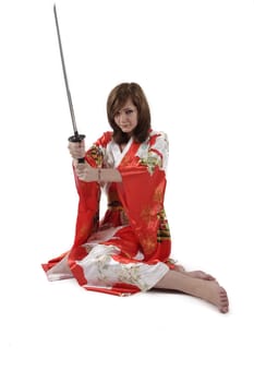 french young girl geisha in red silk kimono with japanese sword