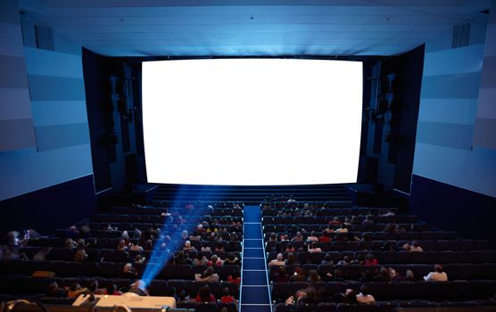 Cinema auditorium with people in chairs watching movie. Light of projector. High angle. Frontal view. Ready for adding your own picture.