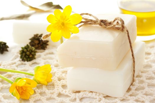 Bars of soap with yellow flowers and oil