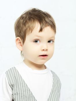 beautiful serious boy portrait, on white background