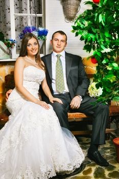 charming bride and groom sitting on bench
