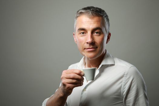 Handsome mature man enjoying a hot drink 