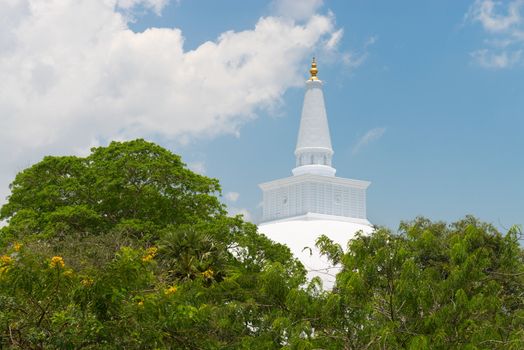 White sacred stupa Ruwanmalisaya above green trees, Anuradhapura, Sri Lanka