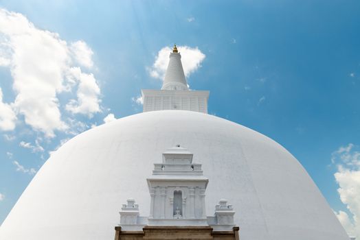 White sacred stupa Ruwanmalisaya under blue sky, Anuradhapura, Sri Lanka