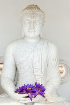  Buddha image statue with fresh flue star water lily or star lotus flowers in hands