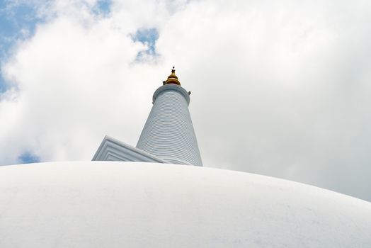 White sacred stupa Ruwanmalisaya under blue sky, Anuradhapura, Sri Lanka